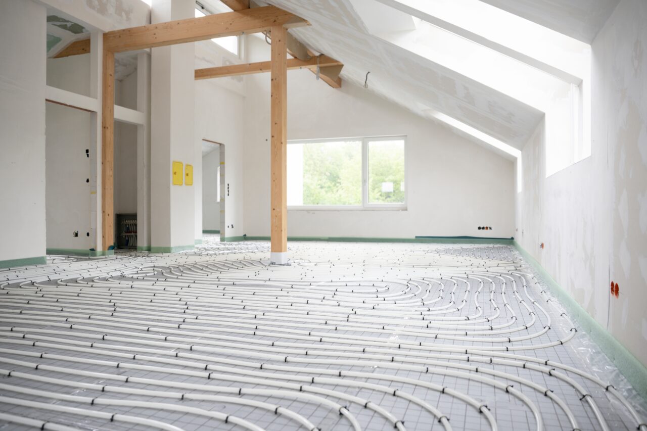Hydronic radiant floor heating installation with PEX tubing during home renovation.