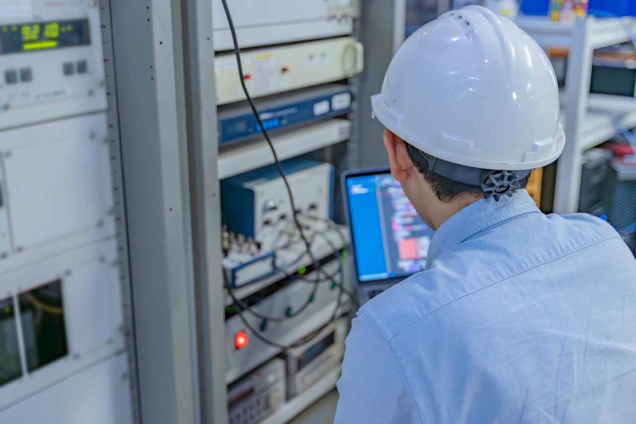 Electrical Engineer Male Checking Voltage At The Power Distribution Cabinet