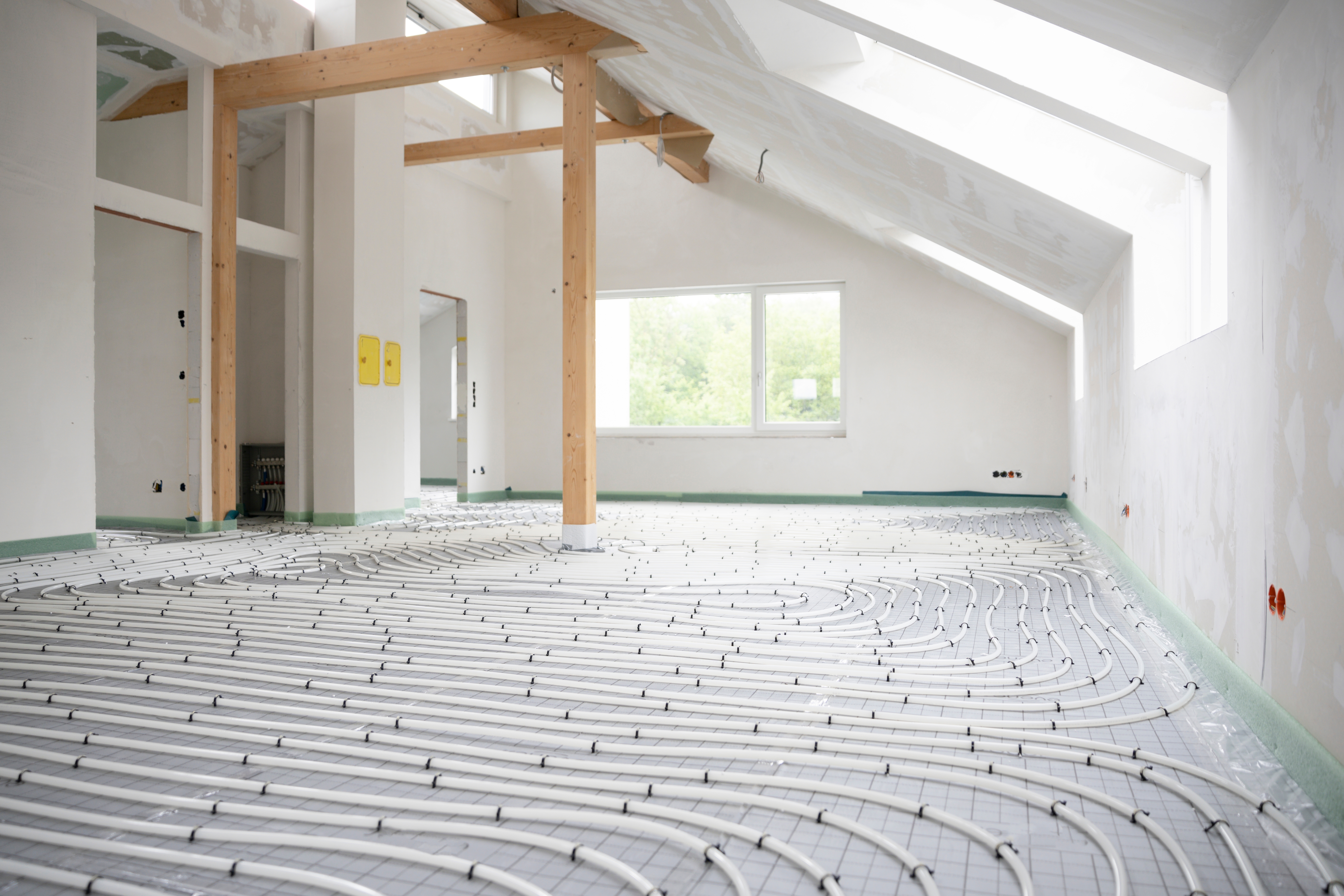Hydronic radiant floor heating installation with PEX tubing during home renovation.