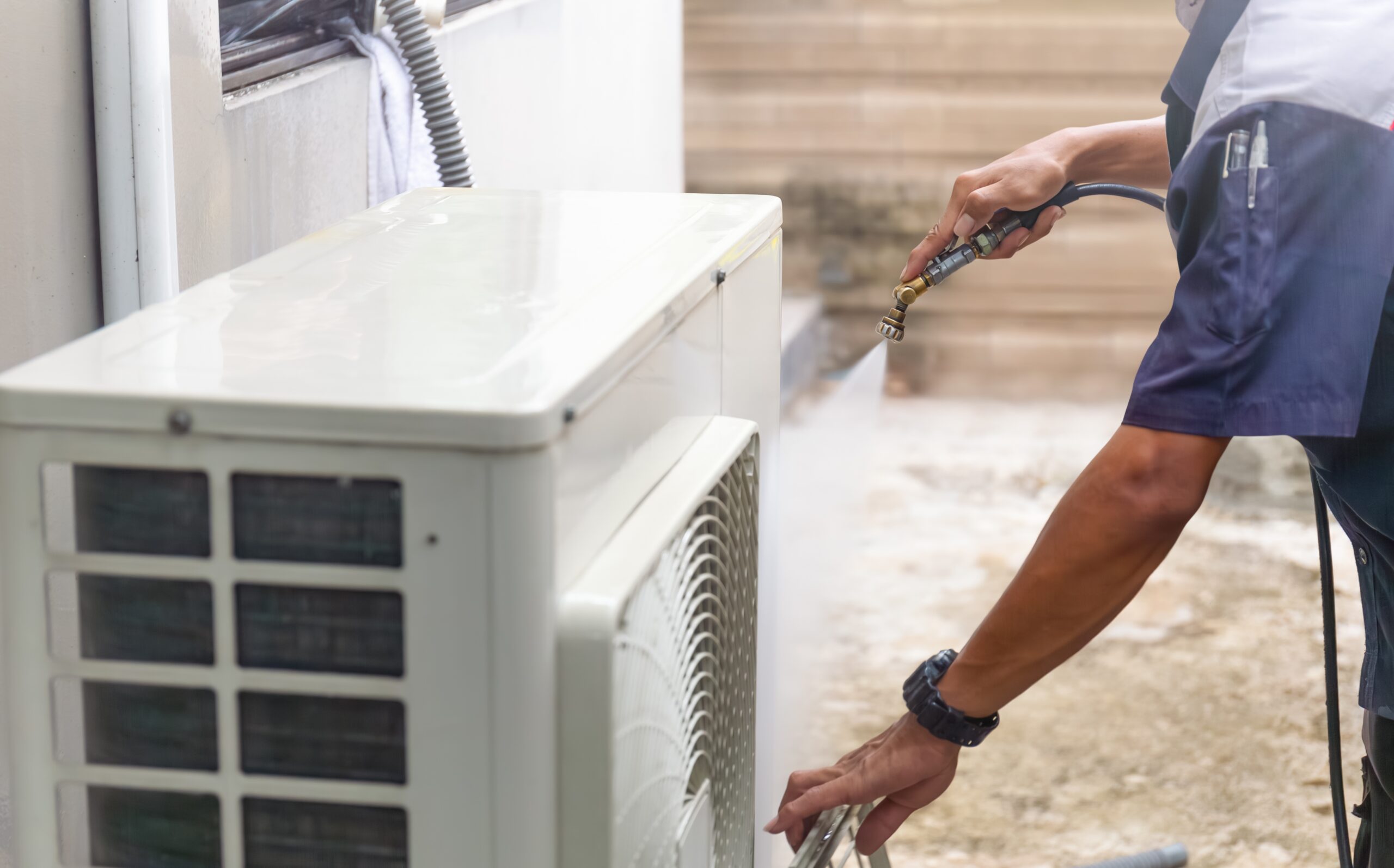 Repairman washing dirty compartments air conditioner