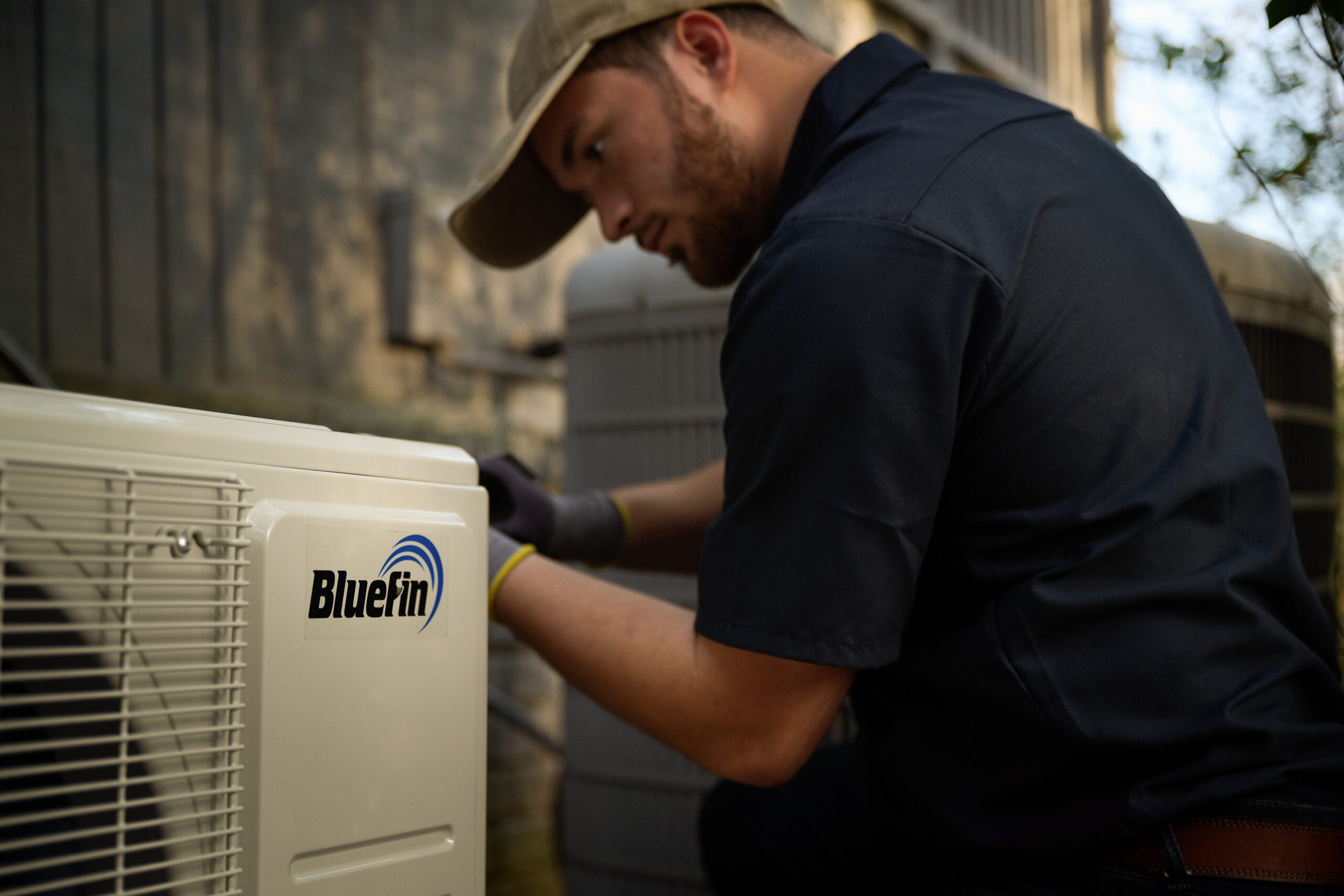 Trades person installing a ductless mini split system