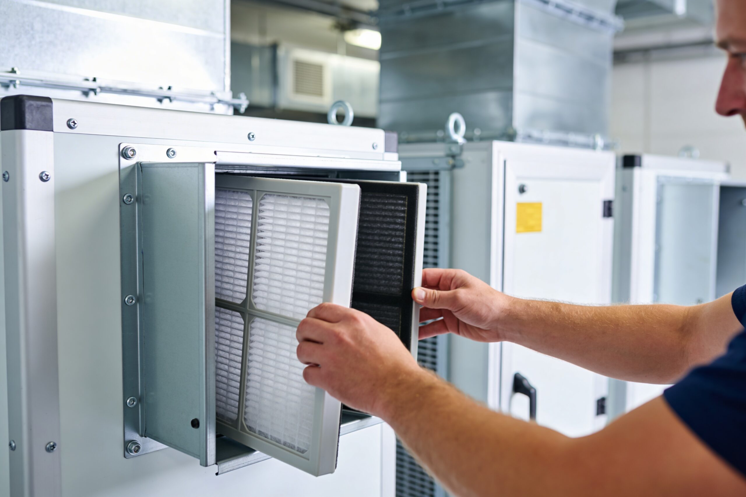 tech inspecting an HVAC filter
