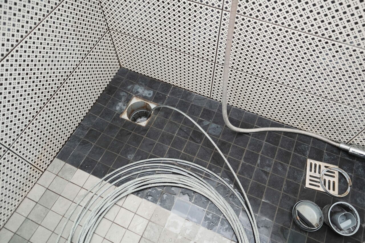 Cleaning the sewer with a snake to unclog the shower