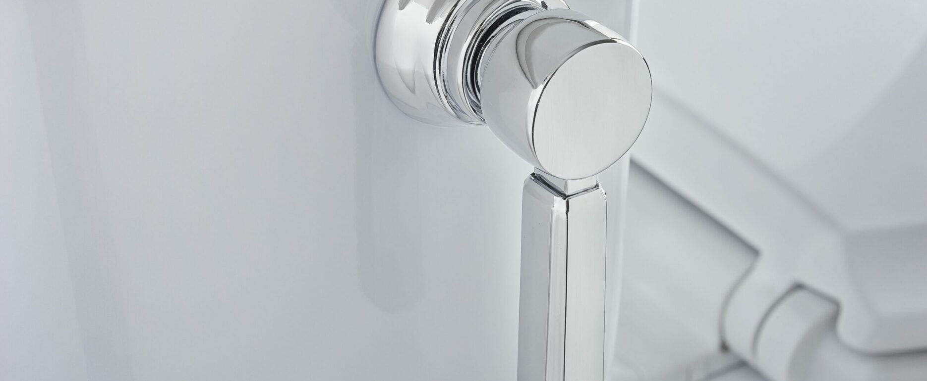 Close Up Toilet Handle Detail In White and Chrome