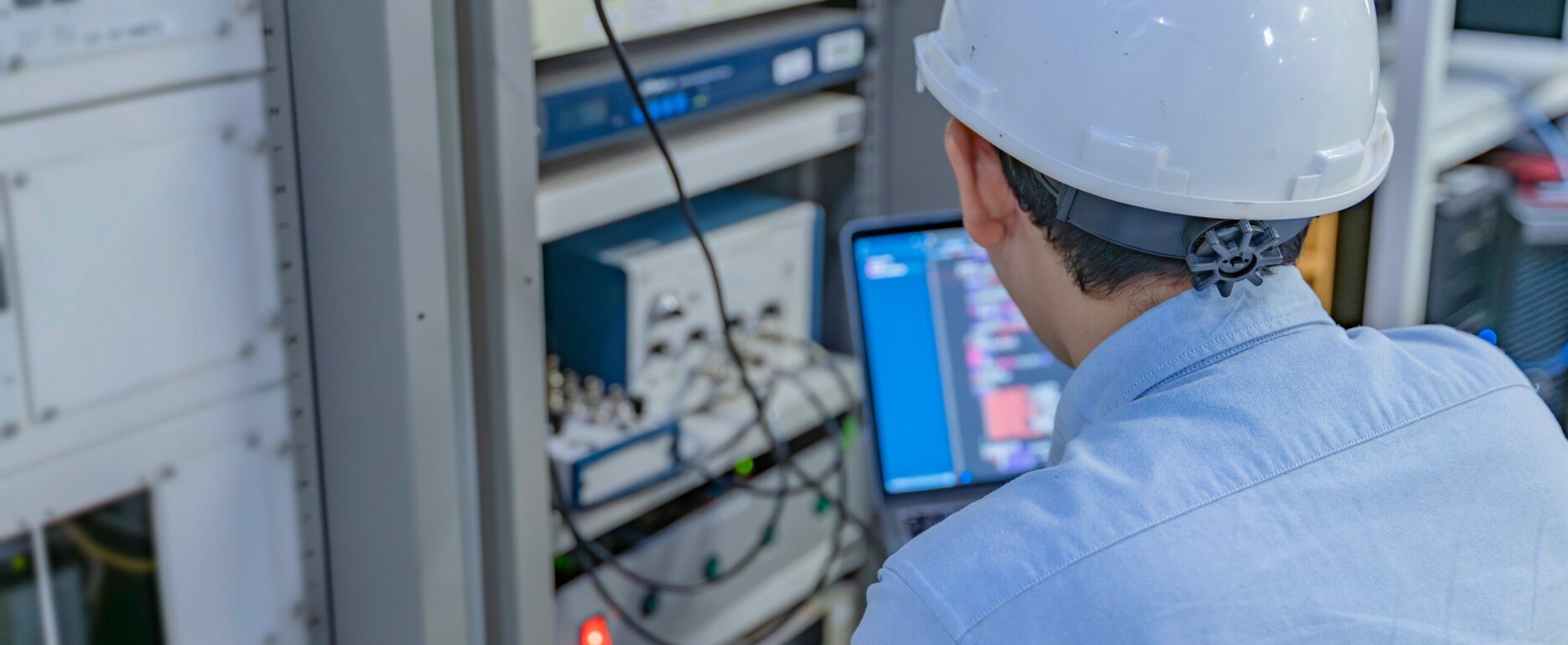 Electrical Engineer Male Checking Voltage At The Power Distribution Cabinet