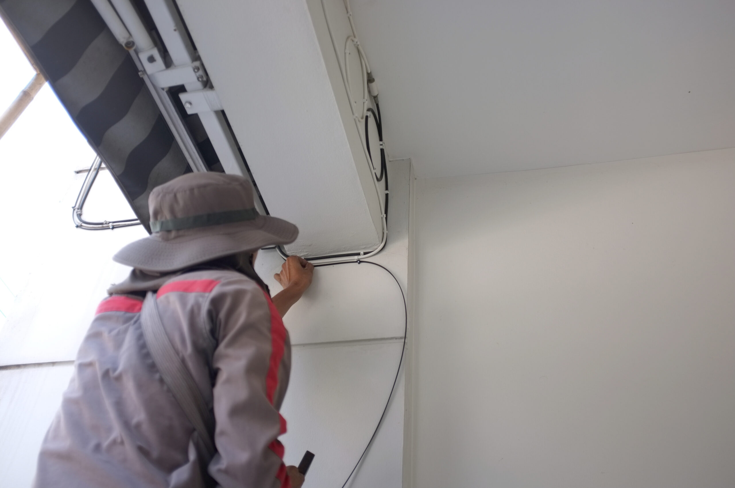 Construction Site Electrician. Worker with Electric Cables.