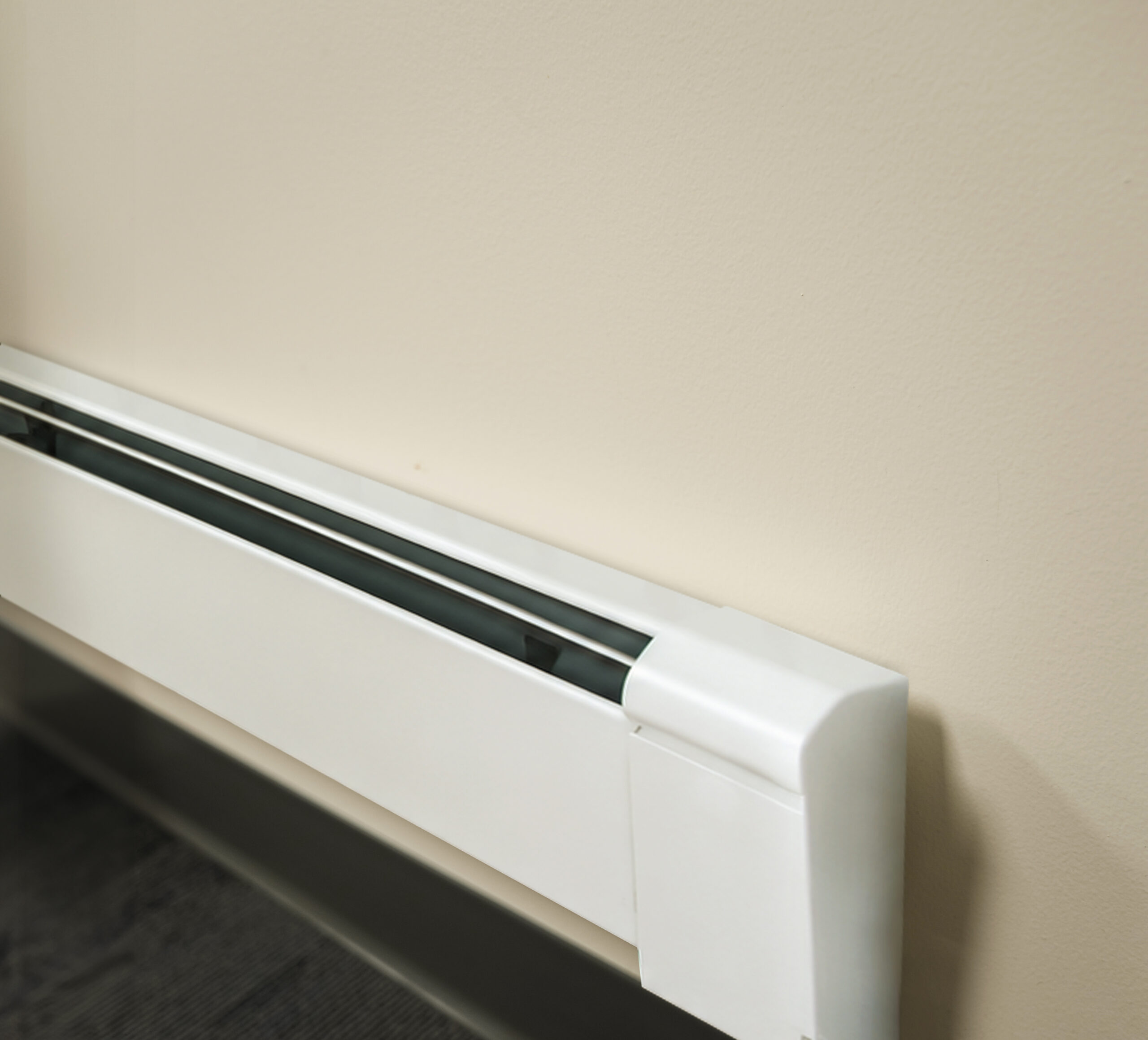 Fin-Tube Baseboard Heater Installed Along a Finished Wall.